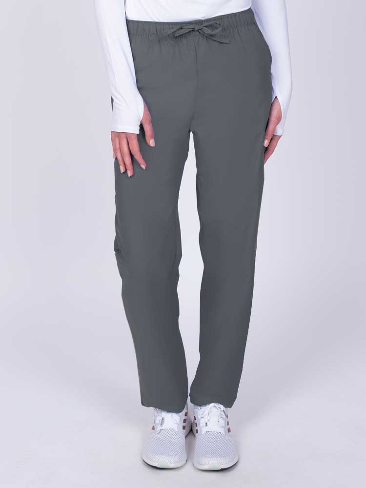 Young woman wearing a Luv Scrubs by MedWorks Women's Elastic Waist Cargo Pant in pewter featuring one cargo pocket on the wearer's left side.