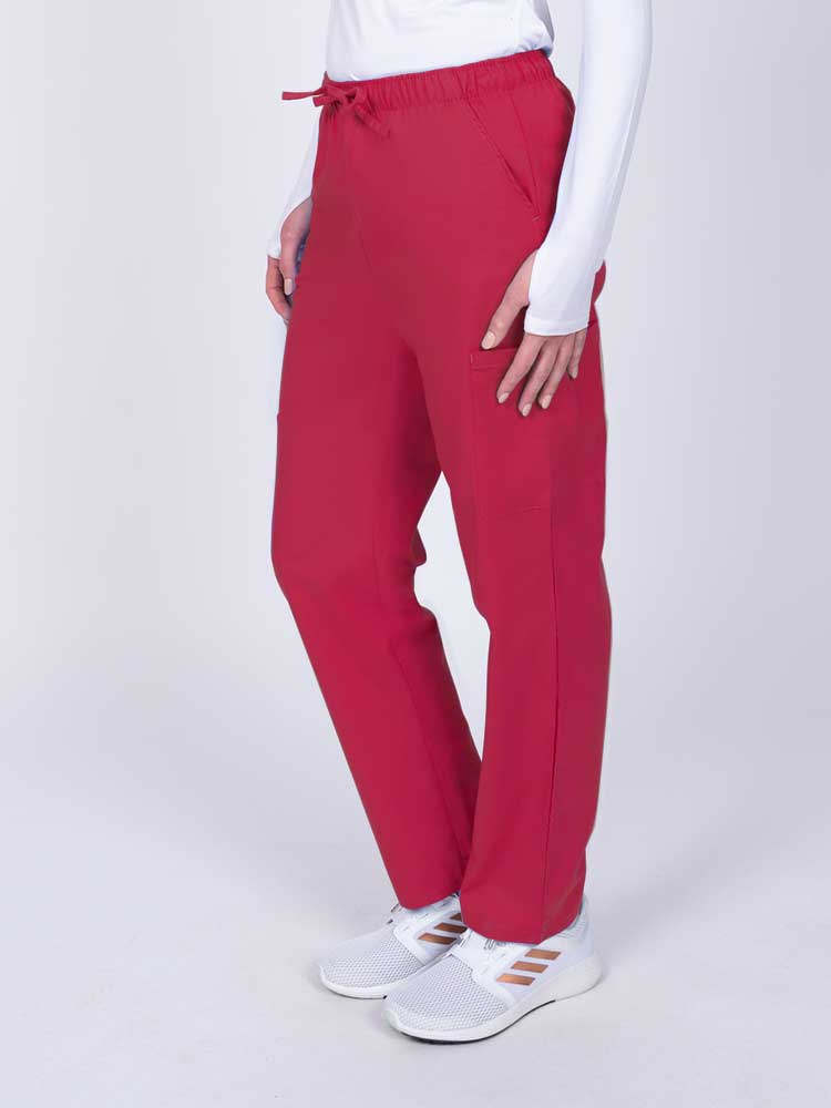 Woman wearing a Luv Scrubs by MedWorks Women's Elastic Waist Cargo Pant in red with 2 front slash pockets.
