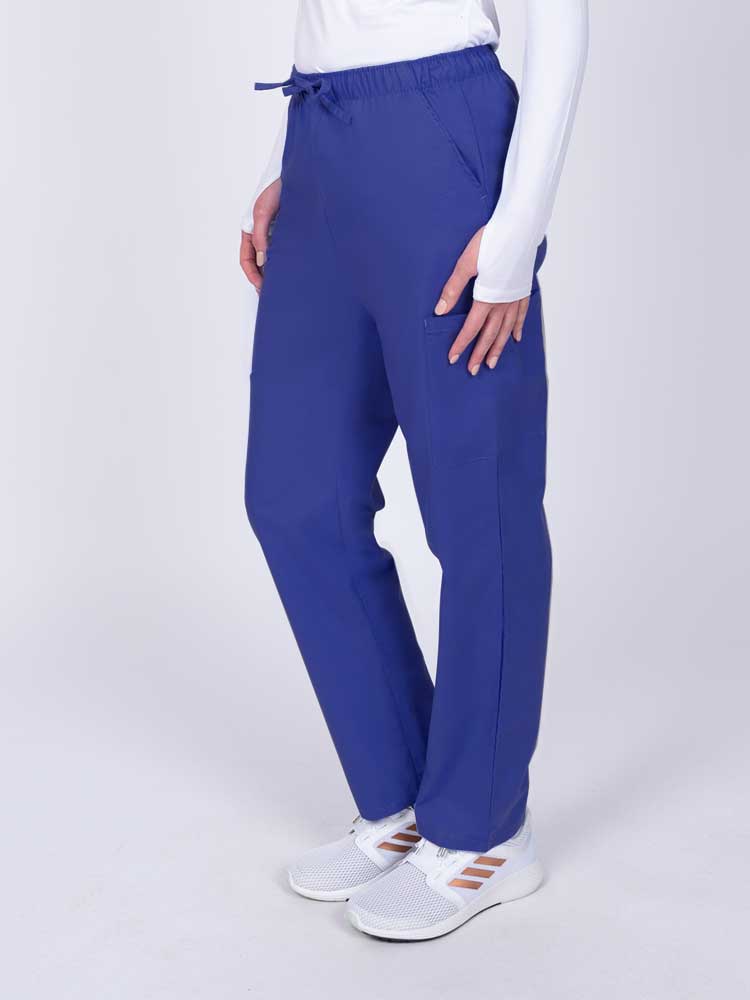 Woman wearing a Luv Scrubs by MedWorks Women's Elastic Waist Cargo Pant in royal with 2 front slash pockets.