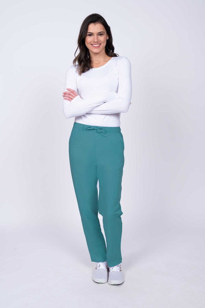 Young healthcare worker wearing a Luv Scrubs by MedWorks Women's Elastic Waist Cargo Pant in teal featuring a natural rise and straight legs.