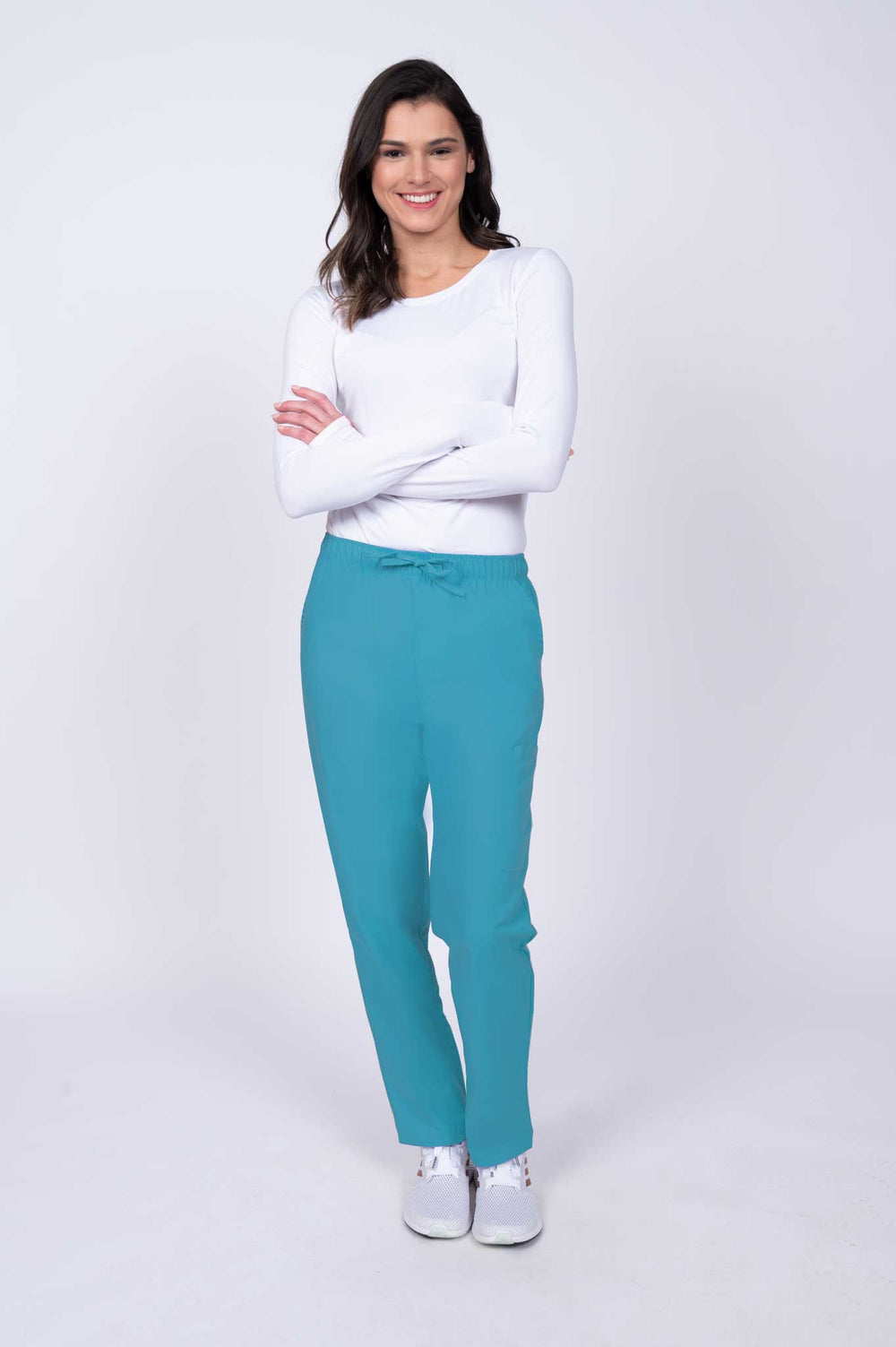 Young healthcare worker wearing a Luv Scrubs by MedWorks Women's Elastic Waist Cargo Pant in turquoise featuring a natural rise and straight legs.