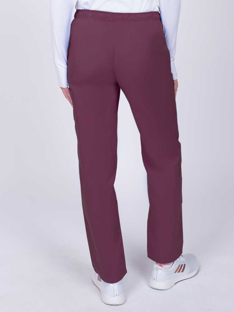 Nurse wearing a Luv Scrubs by MedWorks Women's Elastic Waist Cargo Pant in wine with an elastic and drawstring waist.