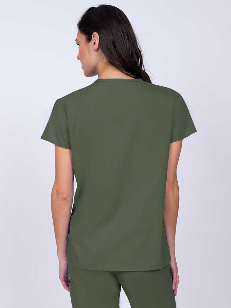 Nurse wearing a Luv Scrubs by MedWorks Women's Mock Wrap Scrub Top in olive with shoulder yokes to ensure a flattering fit.
