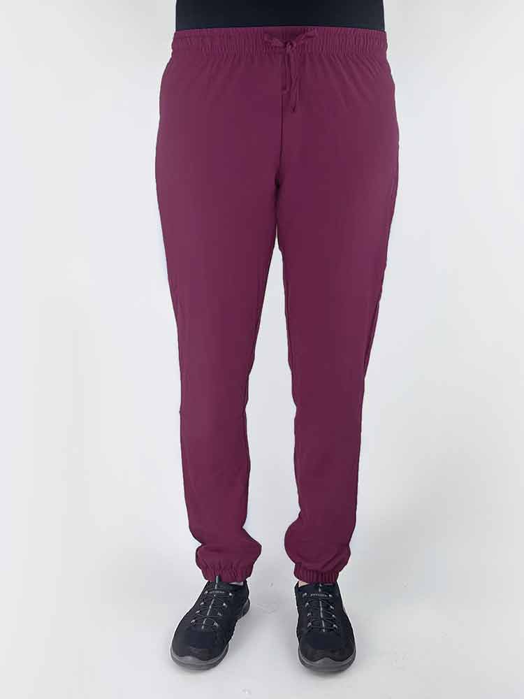 Nurse wearing a Luv Scrubs by MedWorks Women's Pocketless Jogger in wine with an elastic, drawstring waist.