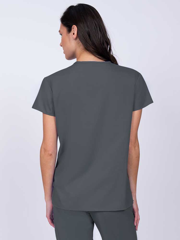 Woman wearing a Luv Scrubs by MedWorks Women's Pocketless Mock Wrap Scrub Top in pewter with shoulder yokes to ensure a flattering fit.