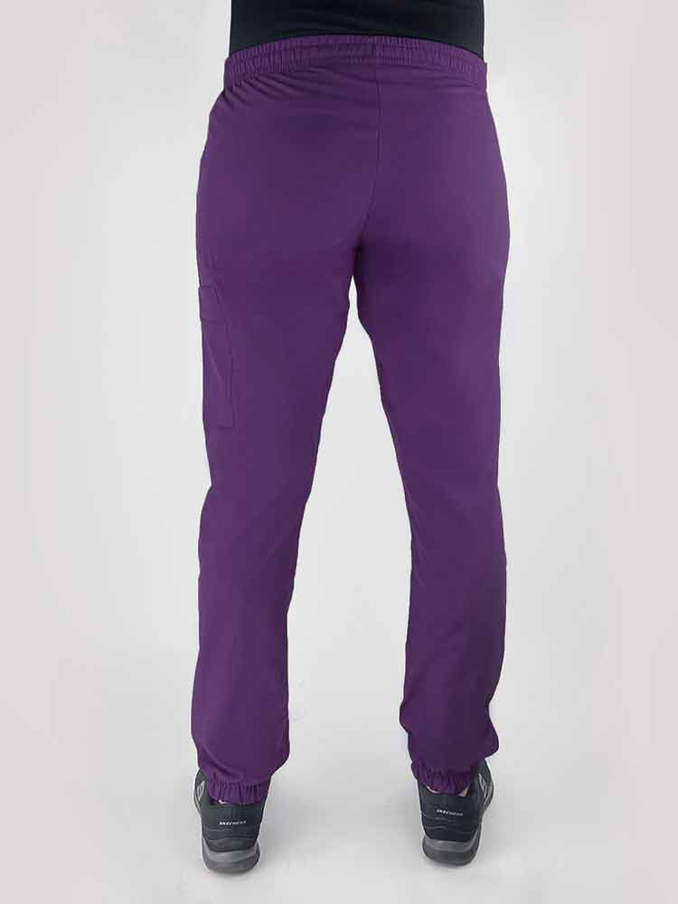 Young woman wearing a Luv Scrubs by MedWorks Women's Scrub Jogger in eggplant with an elastic, drawstring waist.