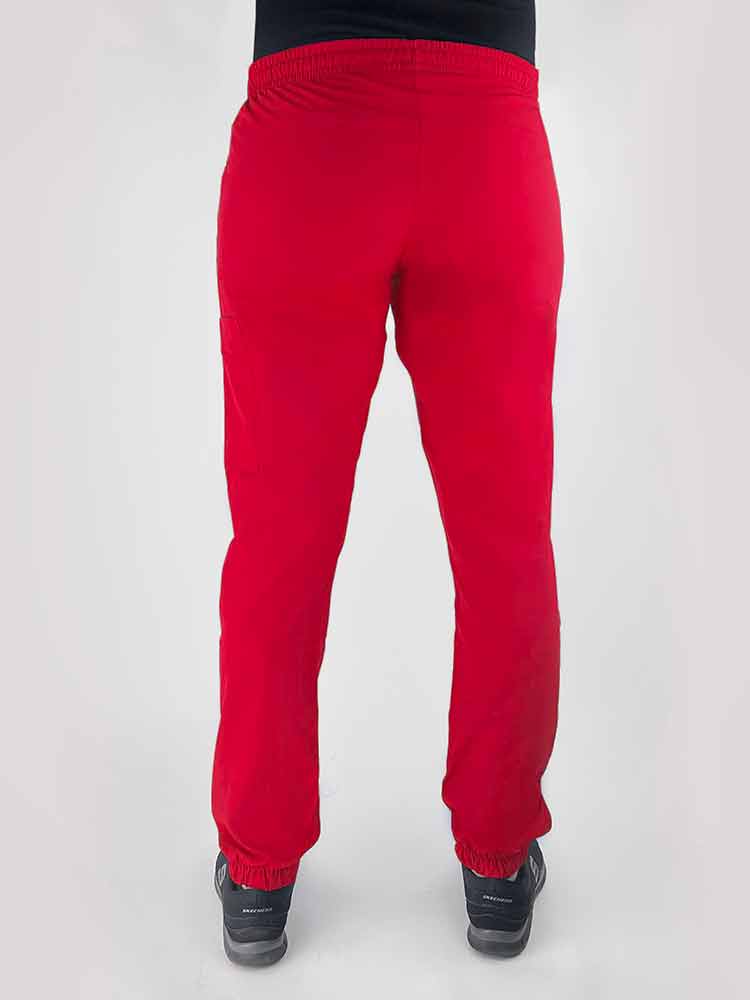 Young woman wearing a Luv Scrubs by MedWorks Women's Scrub Jogger in red with an elastic, drawstring waist.