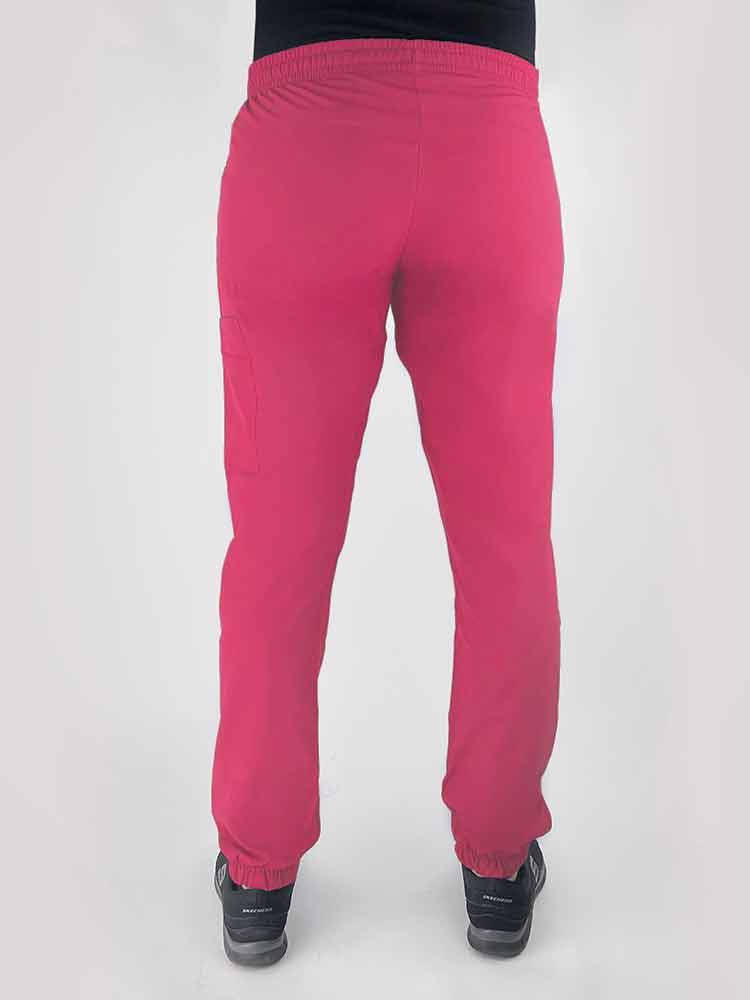 Young woman wearing a Luv Scrubs by MedWorks Women's Scrub Jogger in shocking pink with an elastic, drawstring waist.