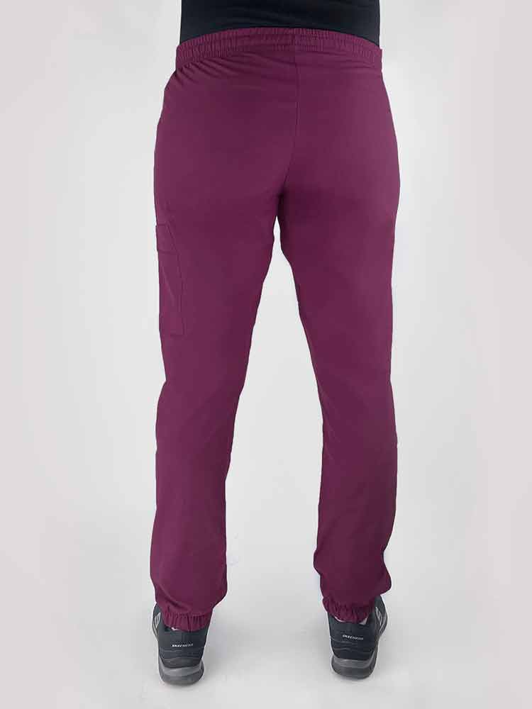 Young woman wearing a Luv Scrubs by MedWorks Women's Scrub Jogger in wine with an elastic, drawstring waist.