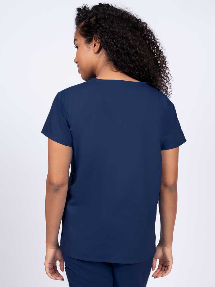 Woman wearing a Luv Scrubs by MedWorks Women's V-neck Scrub Top in navy with a center back length of 26".
