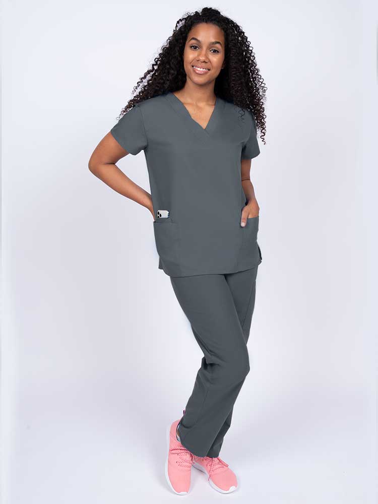 Woman wearing a Luv Scrubs by MedWorks Women's V-neck Scrub Top in pewter with 2 front patch pockets.