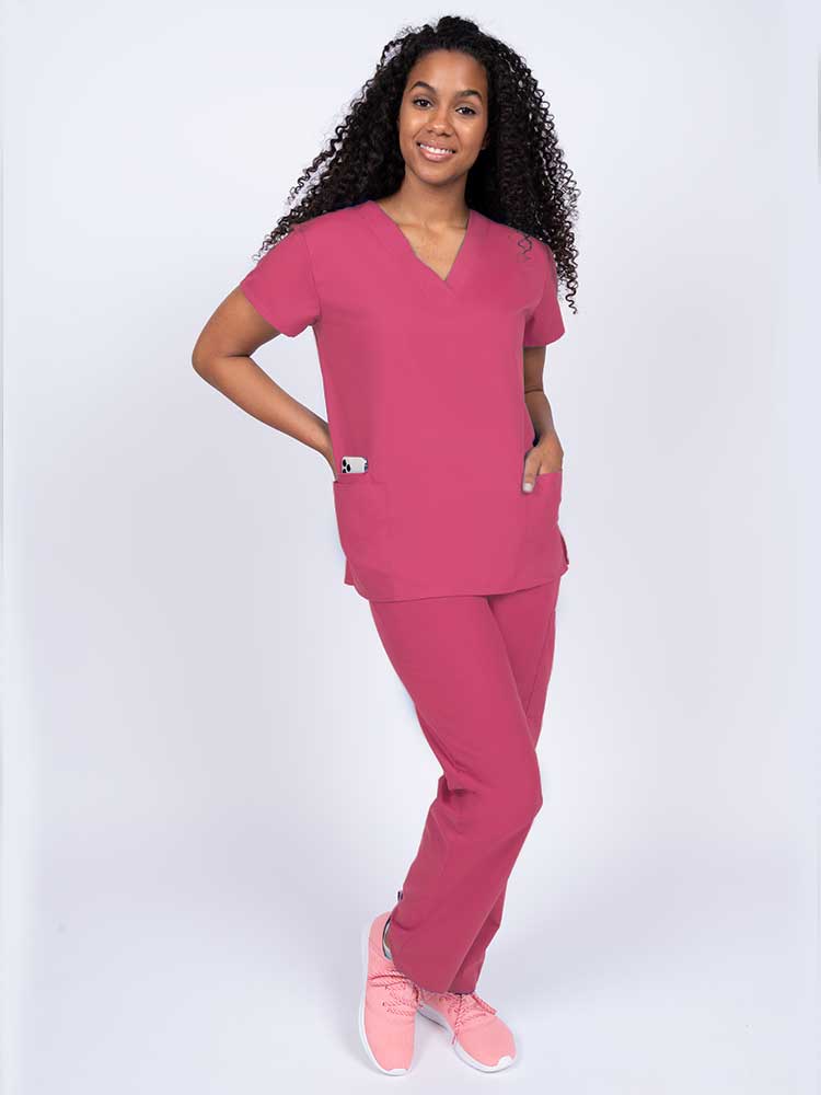 Woman wearing a Luv Scrubs by MedWorks Women's V-neck Scrub Top in shocking pink with 2 front patch pockets.