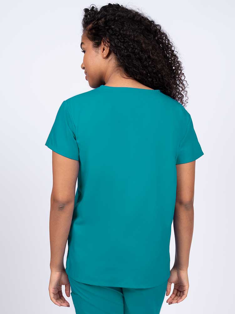 Woman wearing a Luv Scrubs by MedWorks Women's V-neck Scrub Top in teal with a center back length of 26".