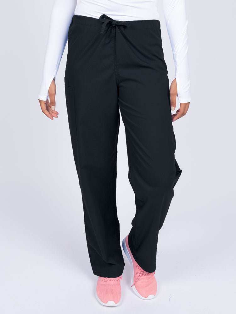 Young nurse wearing a Luv Scrubs Unisex Drawstring Cargo Pant in black with a total of 3 pockets.