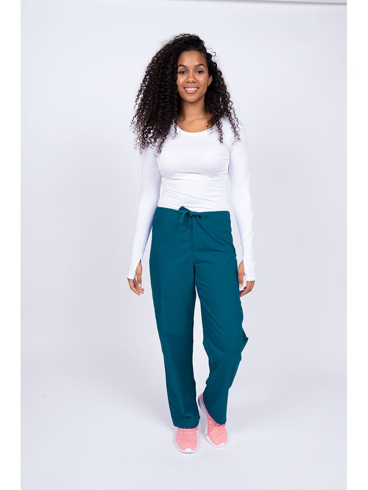 Young nurse wearing a Luv Scrubs Unisex Drawstring Cargo Pant in Caribbean with drawstring waist.