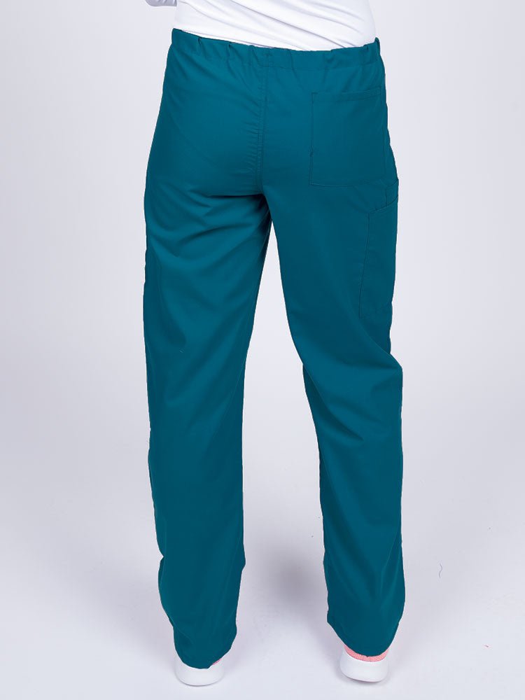 Woman wearing a Luv Scrubs Unisex Drawstring Cargo Pant in Caribbean with one back pocket on the wearer's right side.