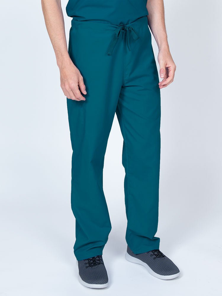 Man wearing a Luv Scrubs Unisex Drawstring Cargo Pant in Caribbean with an inseam of 31".