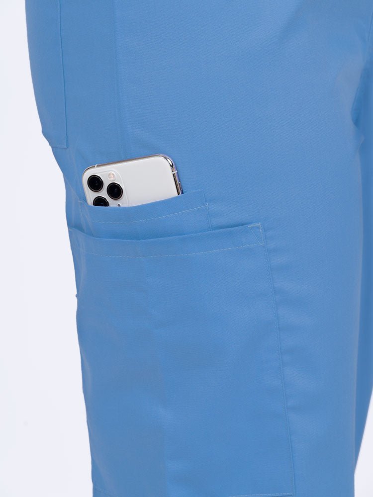 Female nurse wearing a Luv Scrubs Unisex Drawstring Cargo Pant in ceil with 1 cargo & cell phone pocket on the wearer's right side.