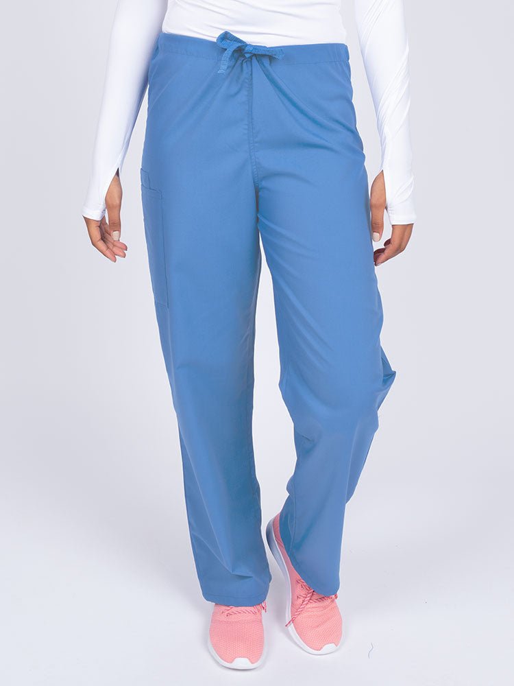 Young nurse wearing a Luv Scrubs Unisex Drawstring Cargo Pant in ceil with a total of 3 pockets.