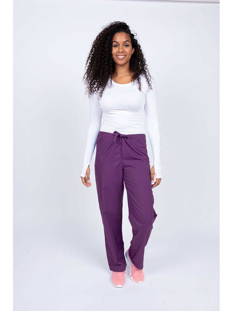 Young nurse wearing a Luv Scrubs Unisex Drawstring Cargo Pant in eggplant with drawstring waist.
