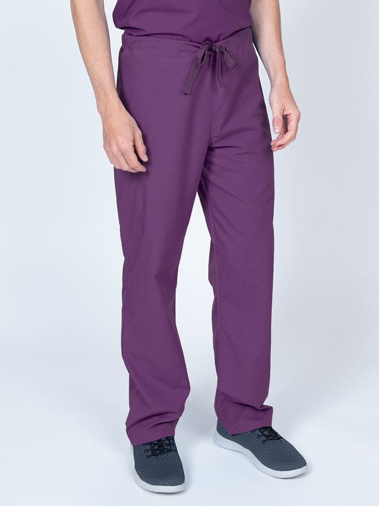 Man wearing a Luv Scrubs Unisex Drawstring Cargo Pant in eggplant with an inseam of 31".
