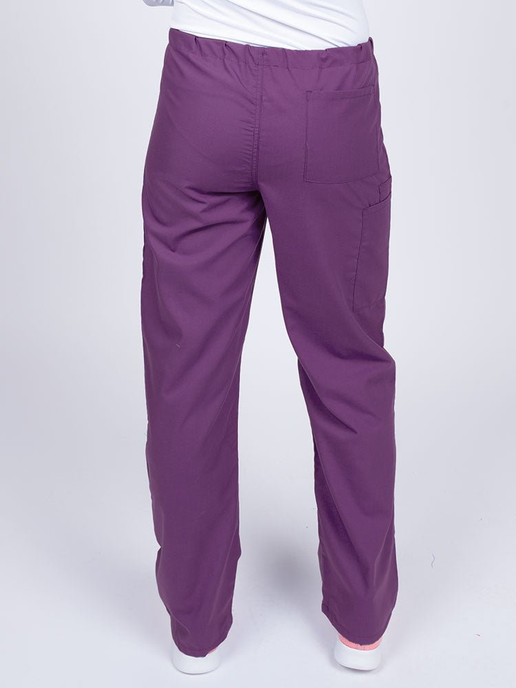 Woman wearing a Luv Scrubs Unisex Drawstring Cargo Pant in eggplant with one back pocket on the wearer's right side.