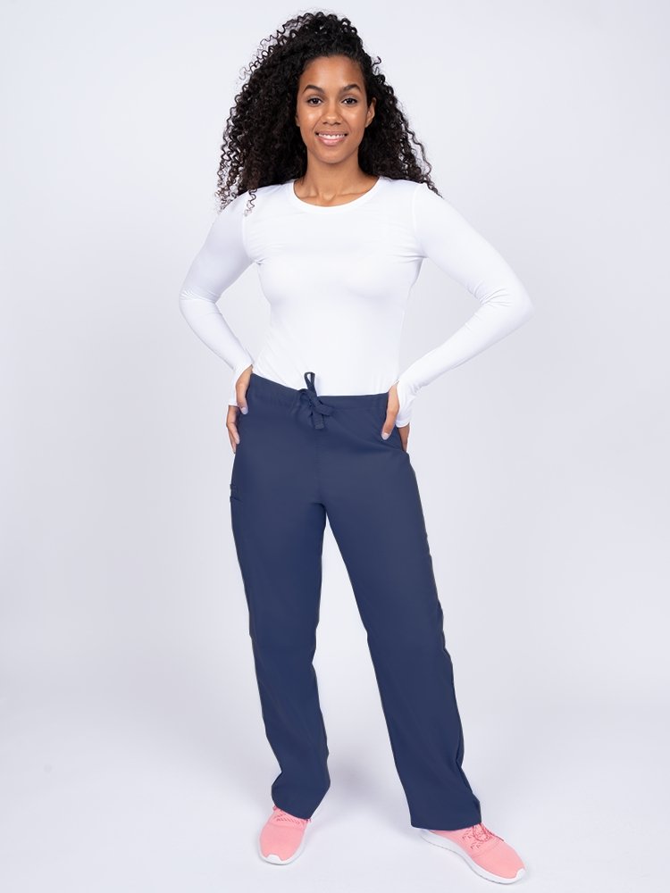 Young woman wearing a Luv Scrubs Unisex Drawstring Cargo Pant in navy.