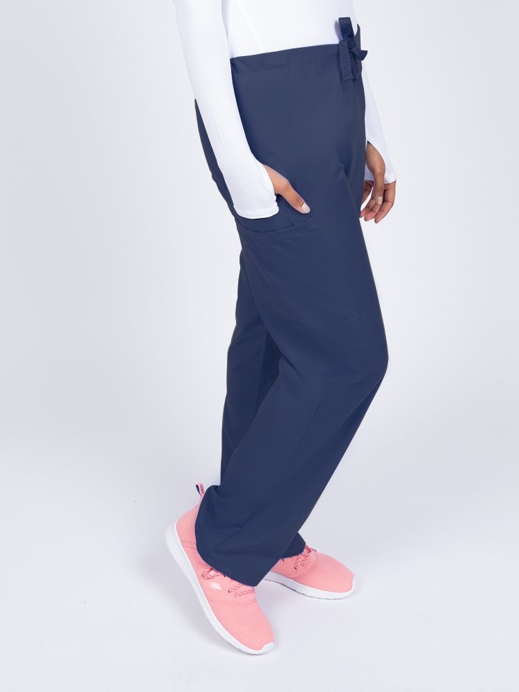 Woman wearing a Luv Scrubs Unisex Drawstring Cargo Pant in navy with 1 cargo pocket.