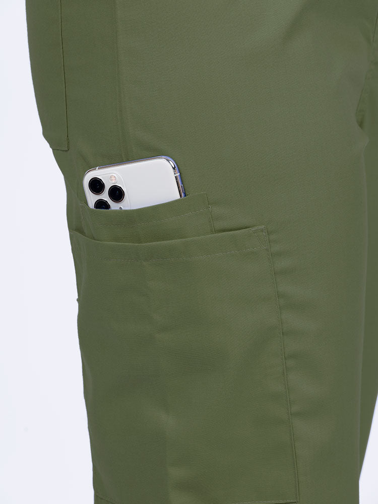 Female nurse wearing a Luv Scrubs Unisex Drawstring Cargo Pant in olive with 1 cargo & cell phone pocket on the wearer's right side.