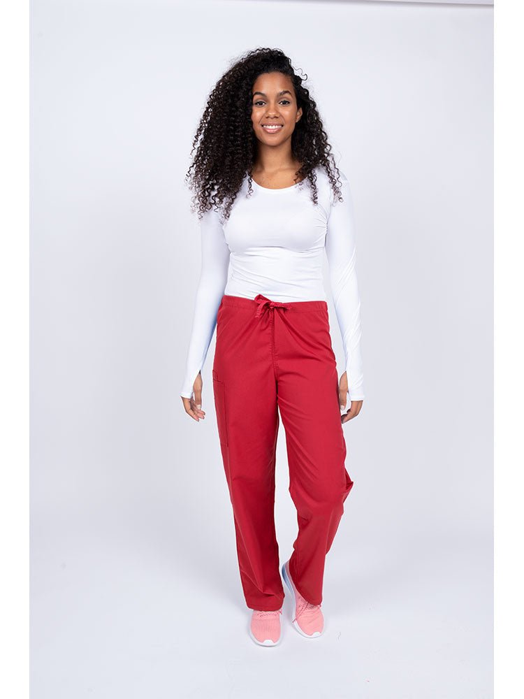 A young Home Health Aide wearing a Luv Scrubs Unisex Drawstring Cargo Pant in Red with drawstring waist.