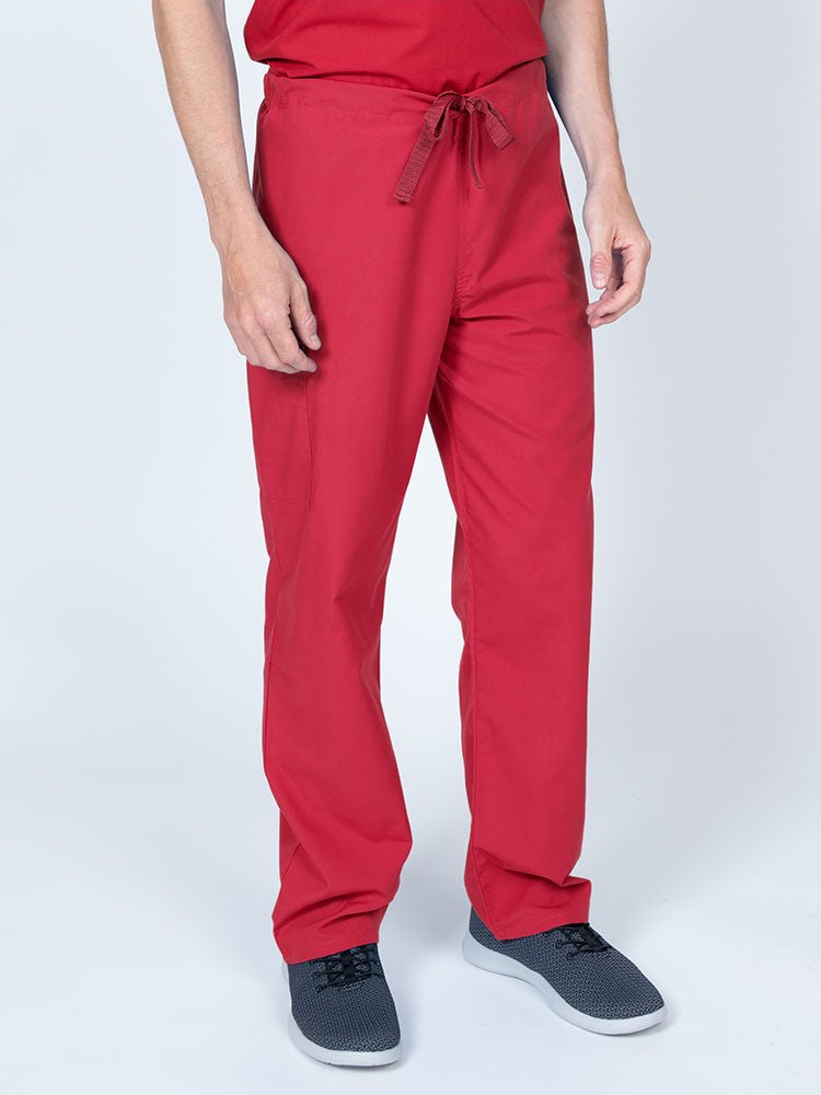 A young male Nurse wearing a Luv Scrubs Unisex Drawstring Cargo Pant in Red with an inseam of 31".