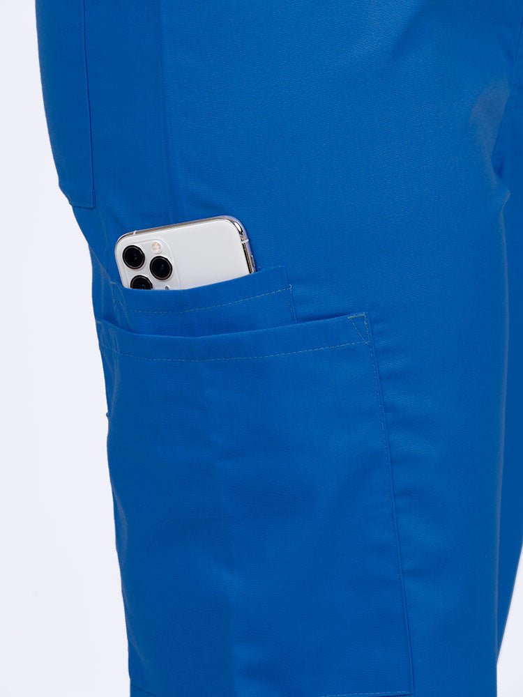 Female nurse wearing a Luv Scrubs Unisex Drawstring Cargo Pant in royal with 1 cargo & cell phone pocket on the wearer's right side.