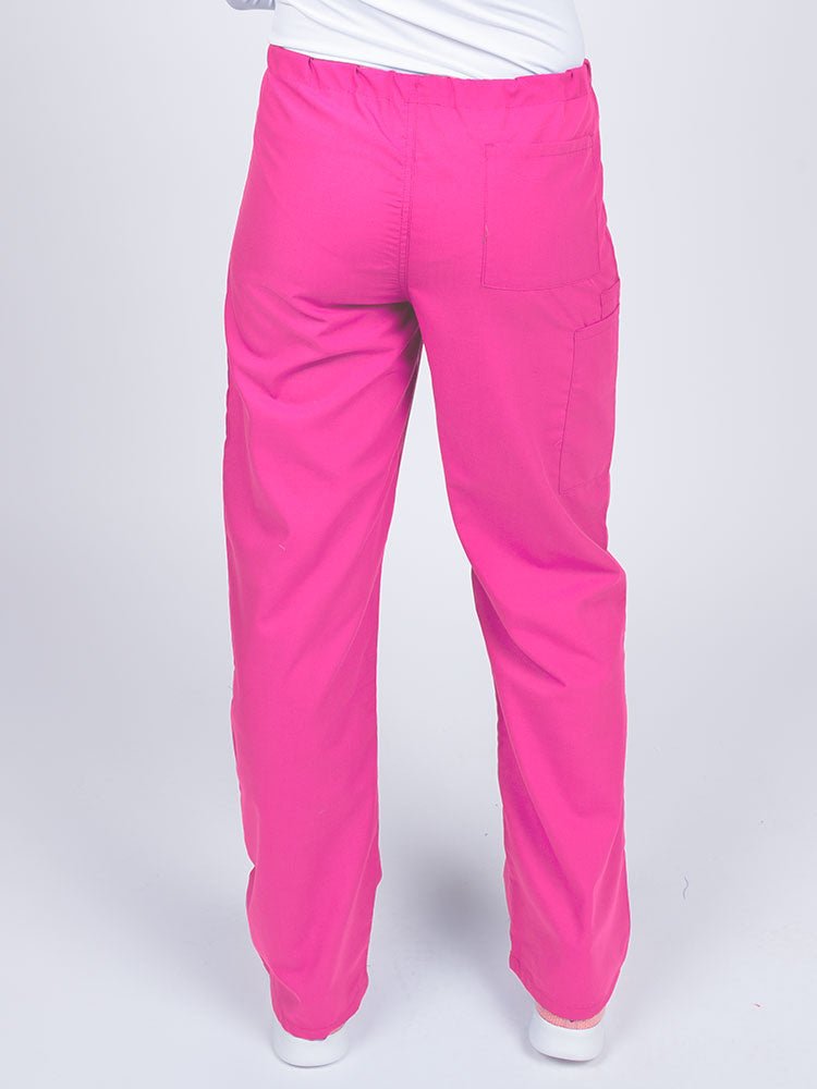 Woman wearing a Luv Scrubs Unisex Drawstring Cargo Pant in shocking pink  with one back pocket on the wearer's right side.