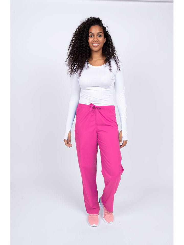 Young nurse wearing a Luv Scrubs Unisex Drawstring Cargo Pant in shocking pink with drawstring waist.