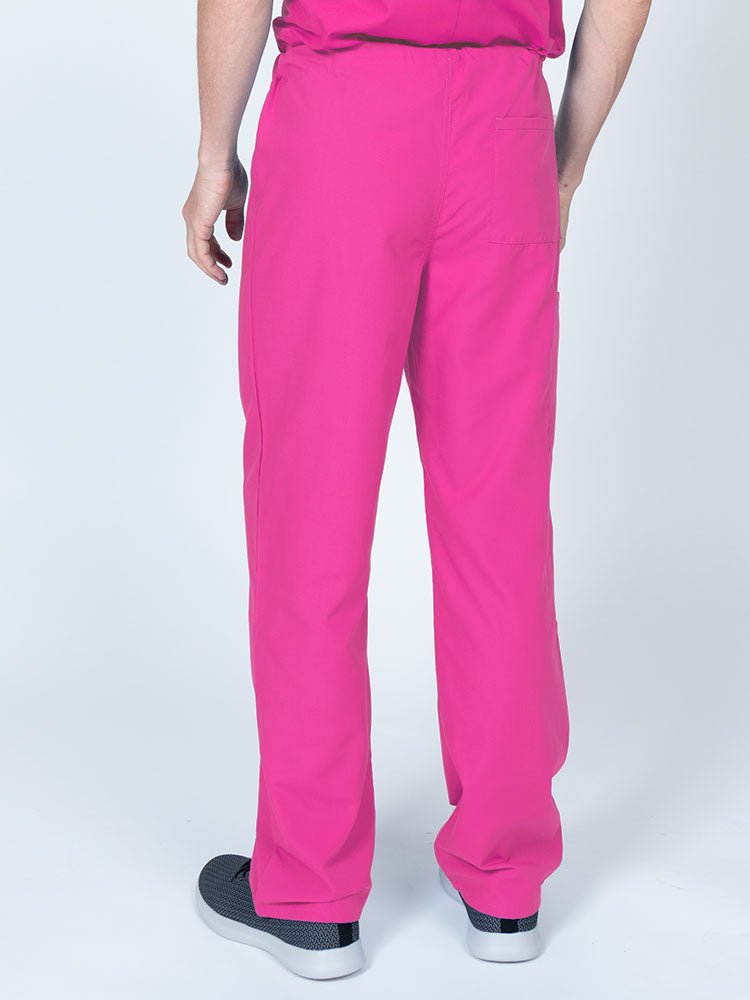 Male nurse wearing a Luv Scrubs Unisex Drawstring Cargo Pant in shocking pink featuring a lightweight, breathable fabric.