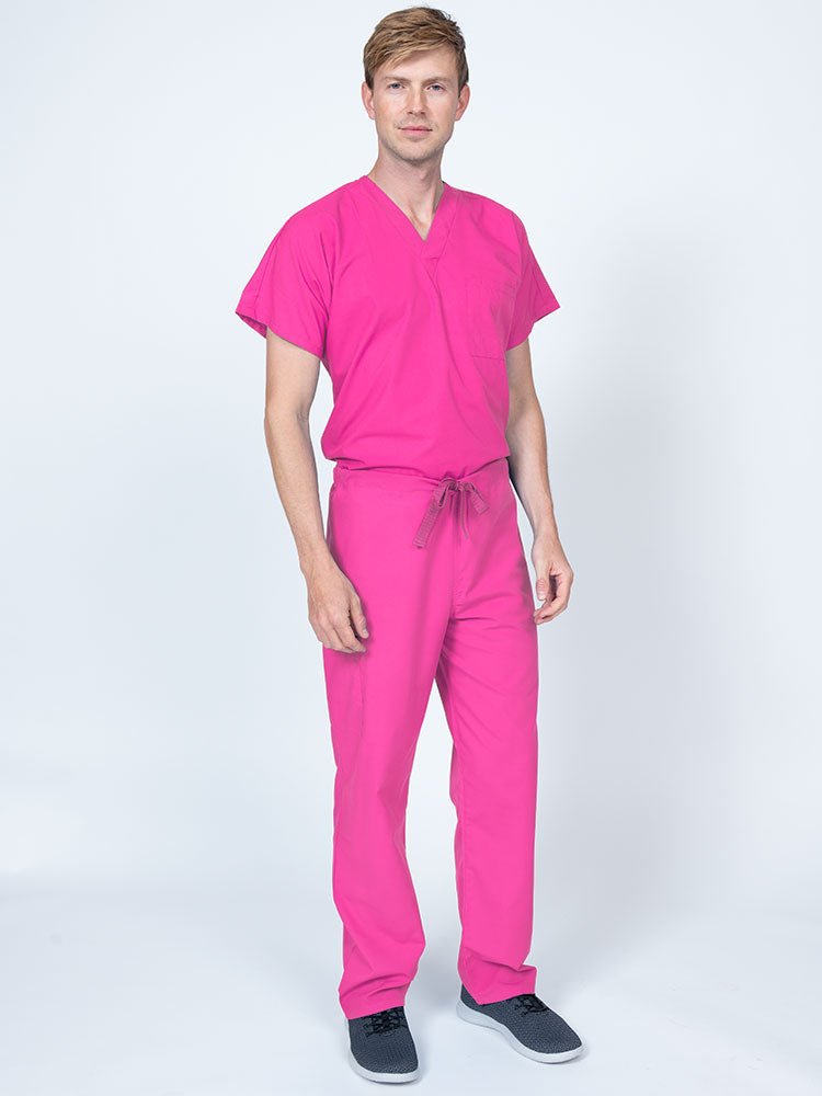 Man wearing a Luv Scrubs Drawstring Cargo Pant in shocking pink featuring a unisex fit.