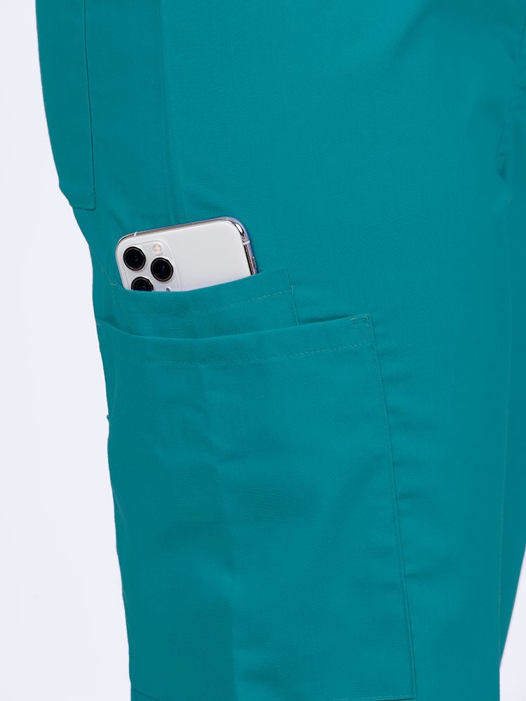 Female nurse wearing a Luv Scrubs Unisex Drawstring Cargo Pant in teal with 1 cargo & cell phone pocket on the wearer's right side.
