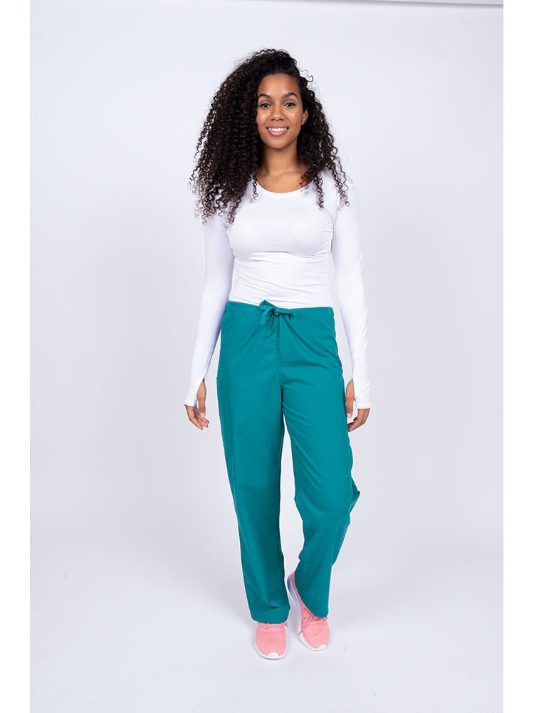Young nurse wearing a Luv Scrubs Unisex Drawstring Cargo Pant in teal with drawstring waist.