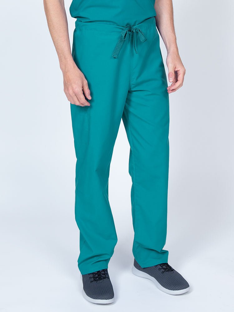 Man wearing a Luv Scrubs Unisex Drawstring Cargo Pant in teal with an inseam of 31".
