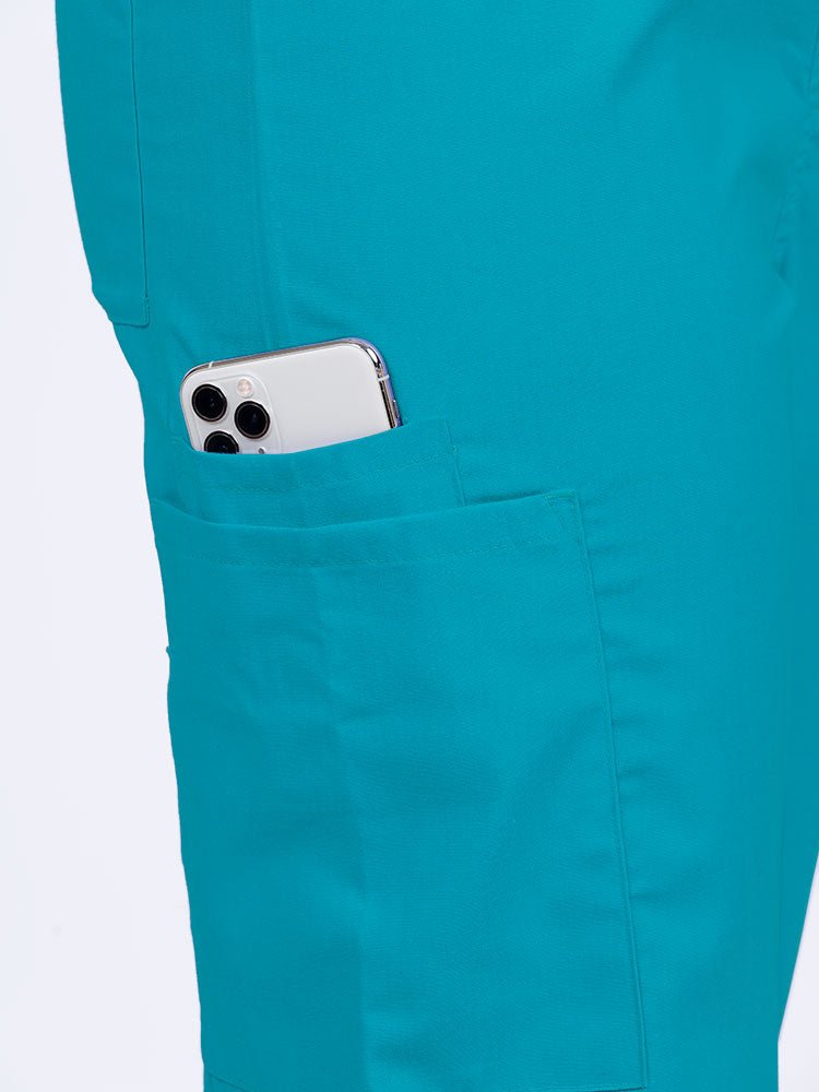 Female nurse wearing a Luv Scrubs Unisex Drawstring Cargo Pant in turquoise with 1 cargo & cell phone pocket on the wearer's right side.