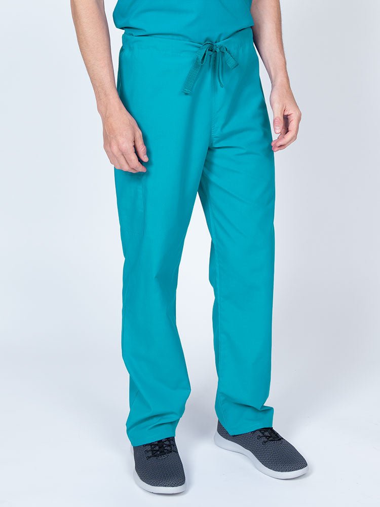 Man wearing a Luv Scrubs Unisex Drawstring Cargo Pant in turquoise with an inseam of 31".