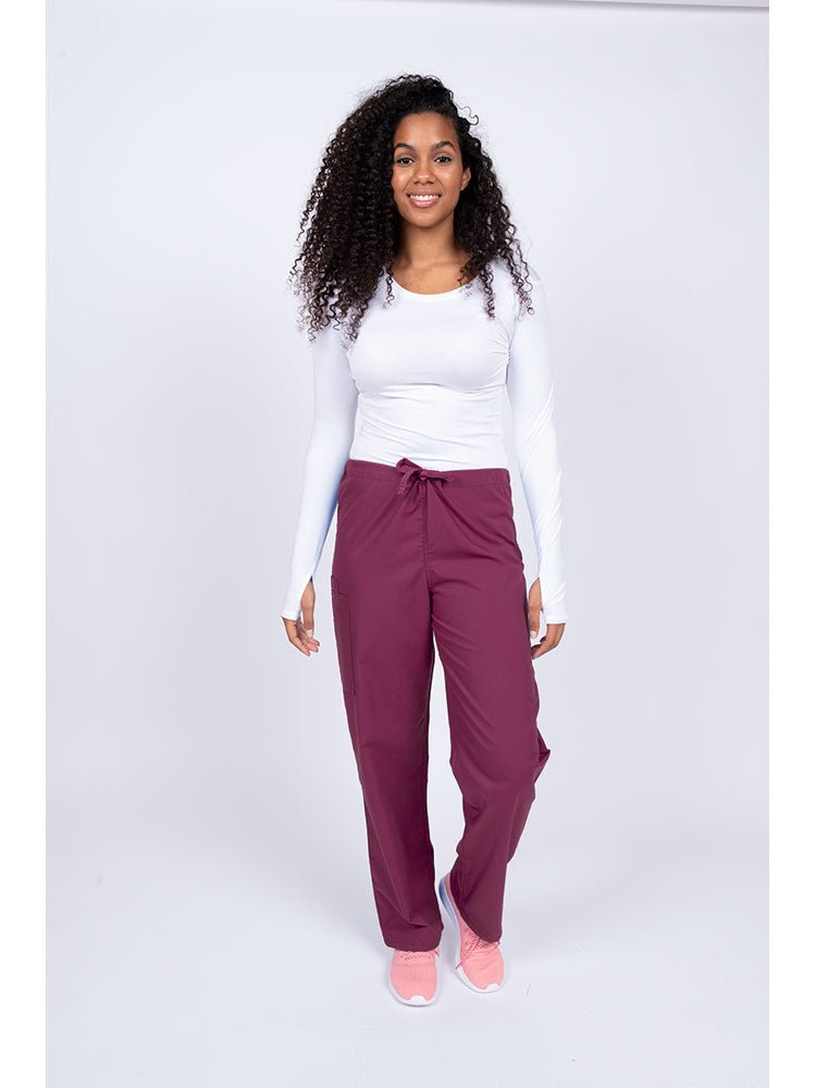 A young Home Health Aide wearing a Luv Scrubs Unisex Drawstring Cargo Pant in wine with drawstring waist.