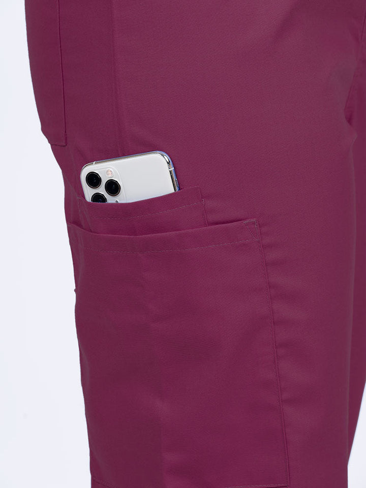 Female Phlebotomist wearing a Luv Scrubs Unisex Drawstring Cargo Pant in wine with 1 cargo & cell phone pocket on the wearer's right side.