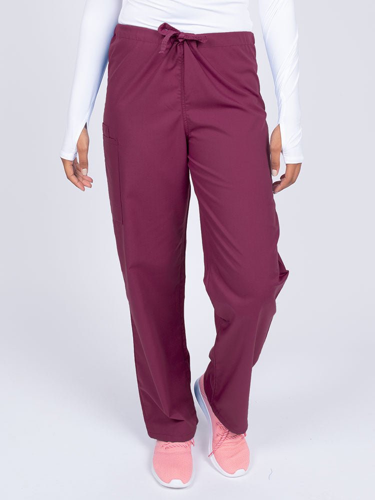 Young female nurse wearing a Luv Scrubs Unisex Drawstring Cargo Pant in wine  with a total of 3 pockets.