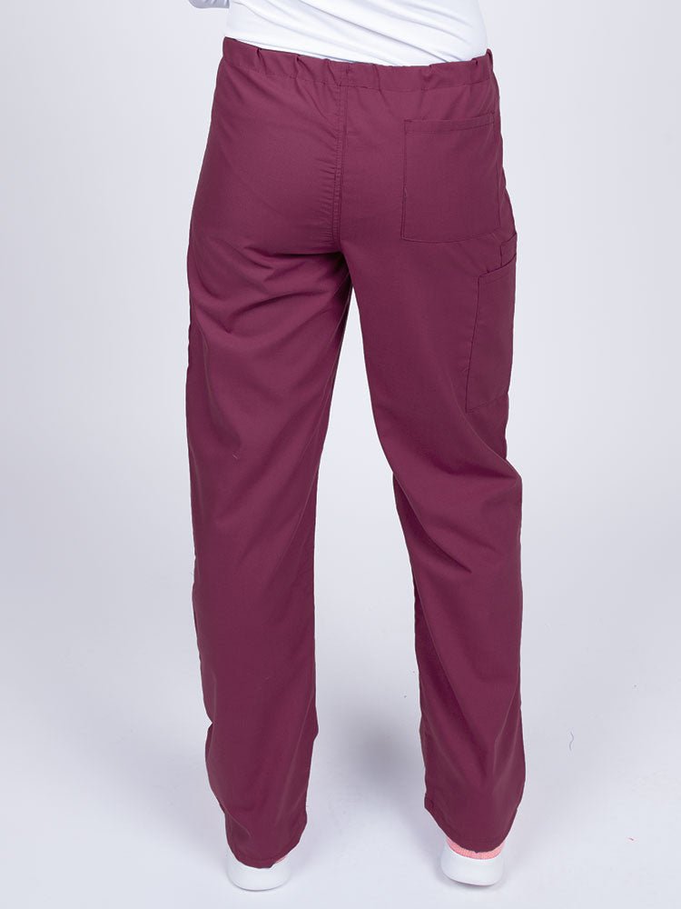 A young female LPN wearing a Luv Scrubs Unisex Drawstring Cargo Pant in wine with one back pocket on the wearer's right side.