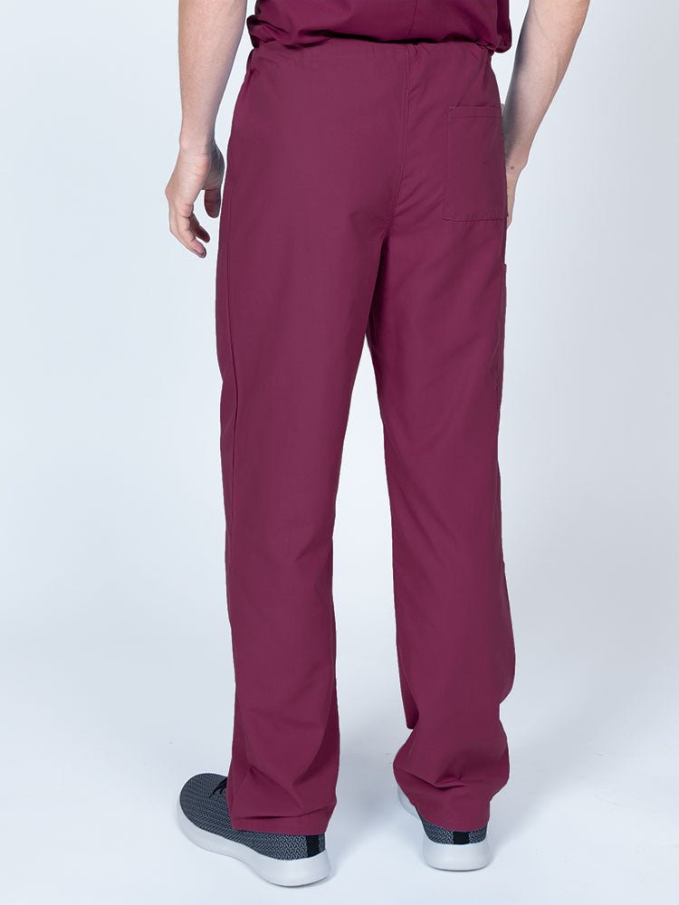 A young male Radiologist nurse wearing a Luv Scrubs Unisex Drawstring Cargo Pant in wine featuring a lightweight, breathable fabric.