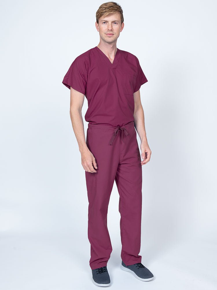 A male Nursing Assistant wearing a Luv Scrubs Drawstring Cargo Pant in wine featuring a unisex fit.