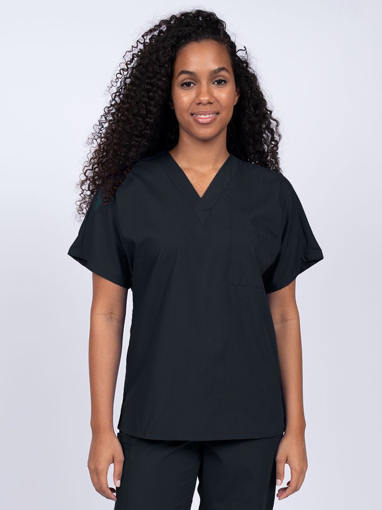 Young female Home Health Aide wearing a Luv Scrubs Unisex Single Pocket Scrub Top in Black featuring a V-neckline.