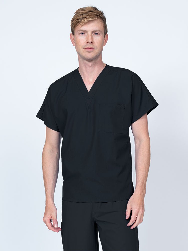 A young male Clinical Laboratory Technologist wearing a Luv Scrubs Unisex Single Pocket V-Neck Scrub Top in Black with dolman sleeves and 1 chest pocket.
