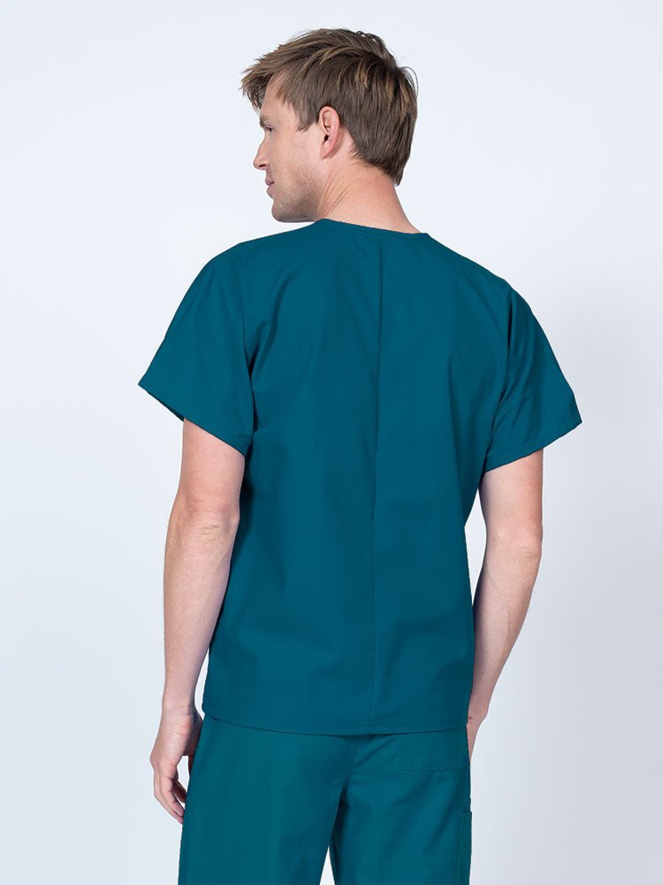Male nurse wearing a Luv Scrubs Unisex Single Pocket V-Neck Scrub Top in Caribbean with a lightweight, breathable fabric made of 55% Cotton and 45% Polyester.